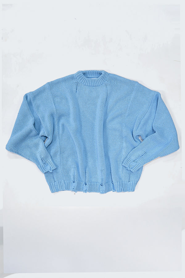 Relaxed flatlay of oversized blue knit sweater with wide body and slouchy fit
