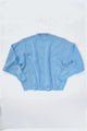 Relaxed flatlay of oversized blue knit sweater with wide body and slouchy fit
