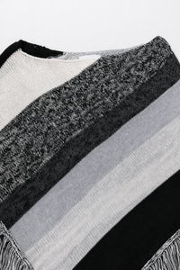 Close-up of neckline on black and grey, cotton, striped knit poncho showing texture