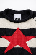 Detail of rollneck, round, neckline of black and cream striped distressed sweater with intarsia red star by Suss Knits