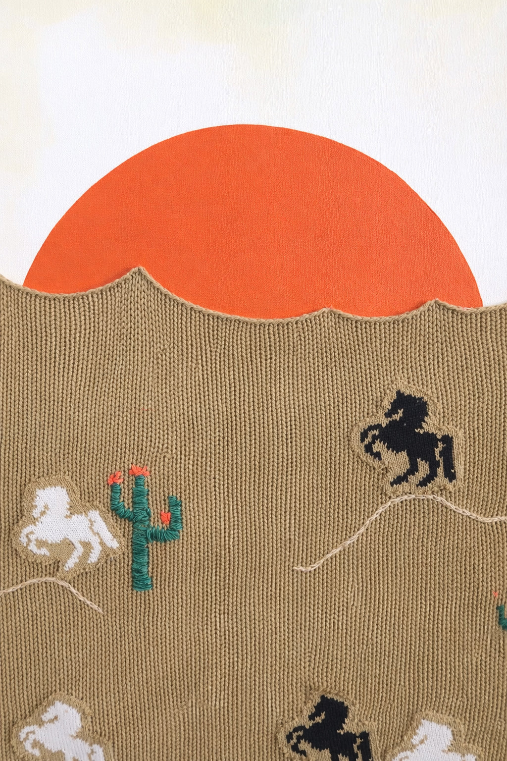 suss knits textile desert landscape with acrylic painted sunset and knit foreground close up