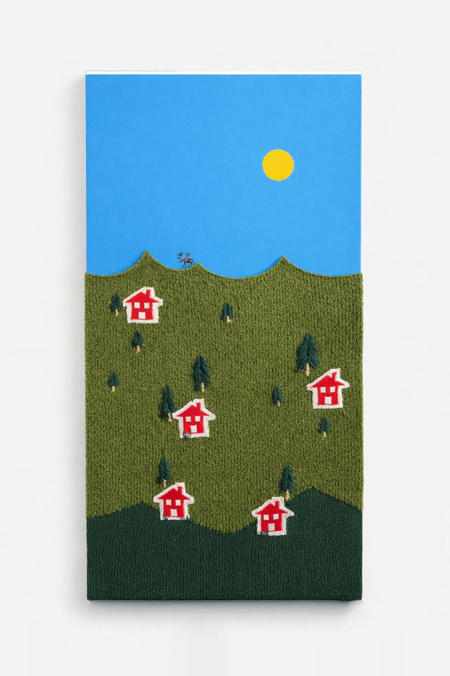 Handmade textile wall art featuring a knitted boucle wool landscape with embroidered trees and houses on an acrylic painted background