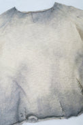Front angle view of the archive finish raglan sweater hand loomed in slub cotton and finished with distressing and hand dye techniques.