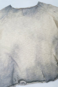 Front angle view of the archive finish raglan sweater hand loomed in slub cotton and finished with distressing and hand dye techniques.