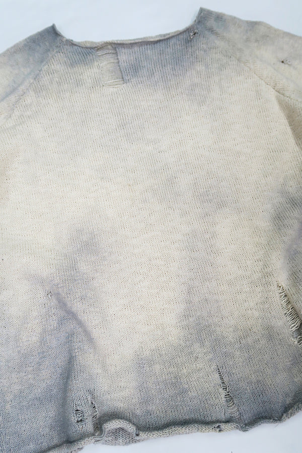 Front angle view of the archive finish raglan sweater hand loomed in slub cotton and finished with distressing and hand dye techniques.