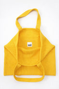 Inside of yellow knit tote bag showing thick double knit lining and interior pocket by Suss Knits