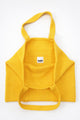 Inside of yellow knit tote bag showing thick double knit lining and interior pocket by Suss Knits