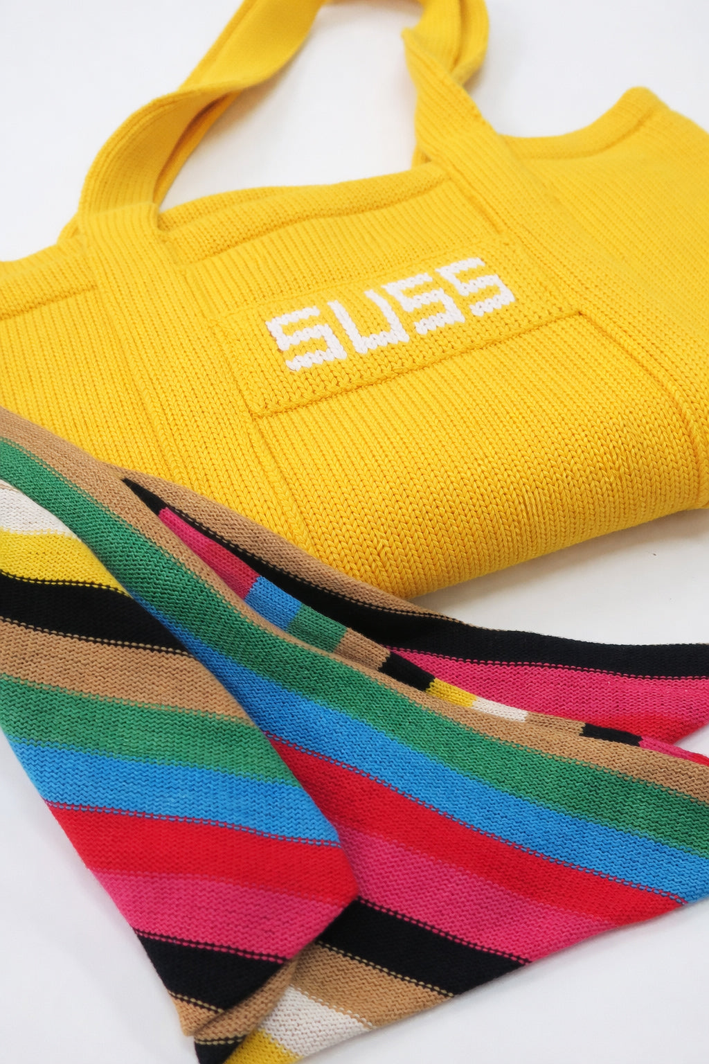 Yellow knit tote bag folded with multistripe scarf styled detail, hand loomed cotton by Suss Knits