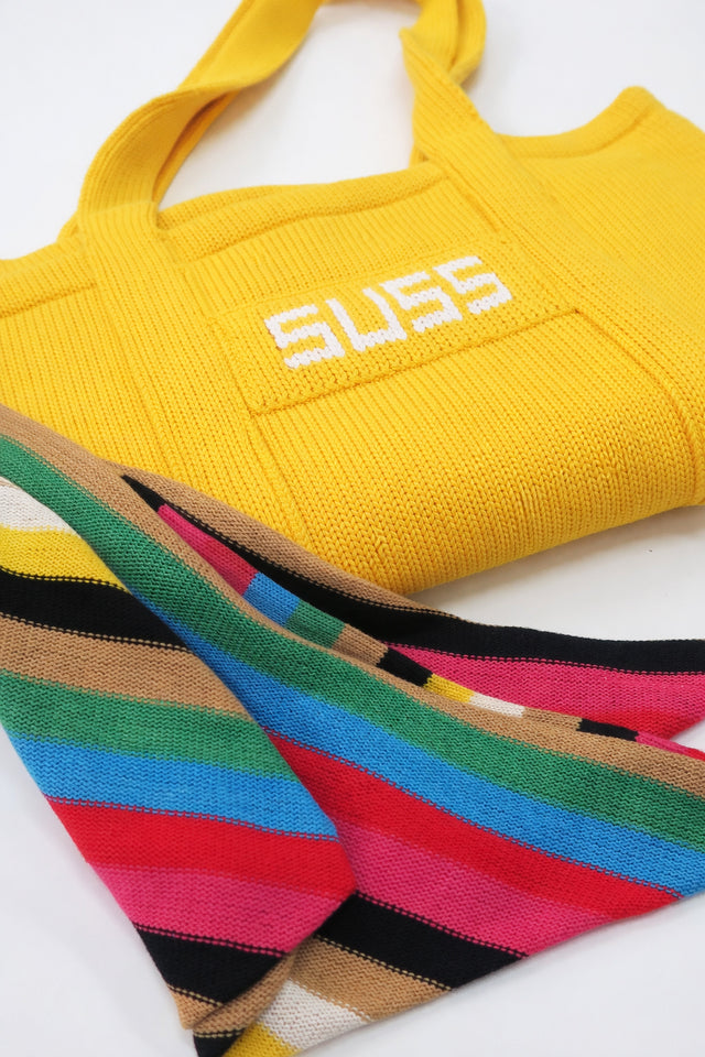 Yellow knit tote bag folded with multistripe scarf styled detail, hand loomed cotton by Suss Knits
