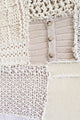 Close-up of hand knit patchwork textile wall art and button swatch showing mixed stitch patterns and textures in neutral cream tones