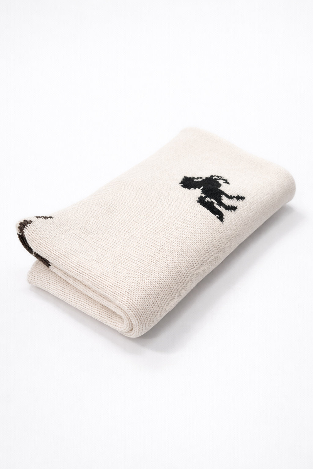 folded cream knit poncho lightweight travel friendly